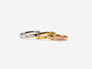 three different colored gold and silver wedding rings